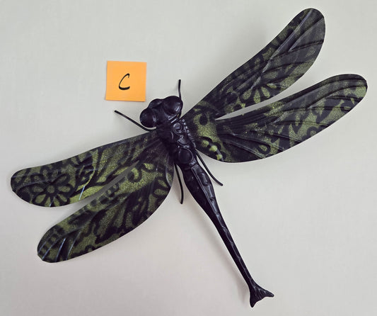 Decorative dragonfly wall art on a plain background