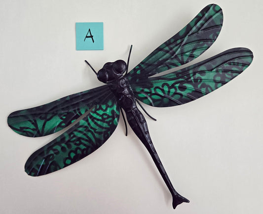 Decorative dragonfly wall art on a plain background