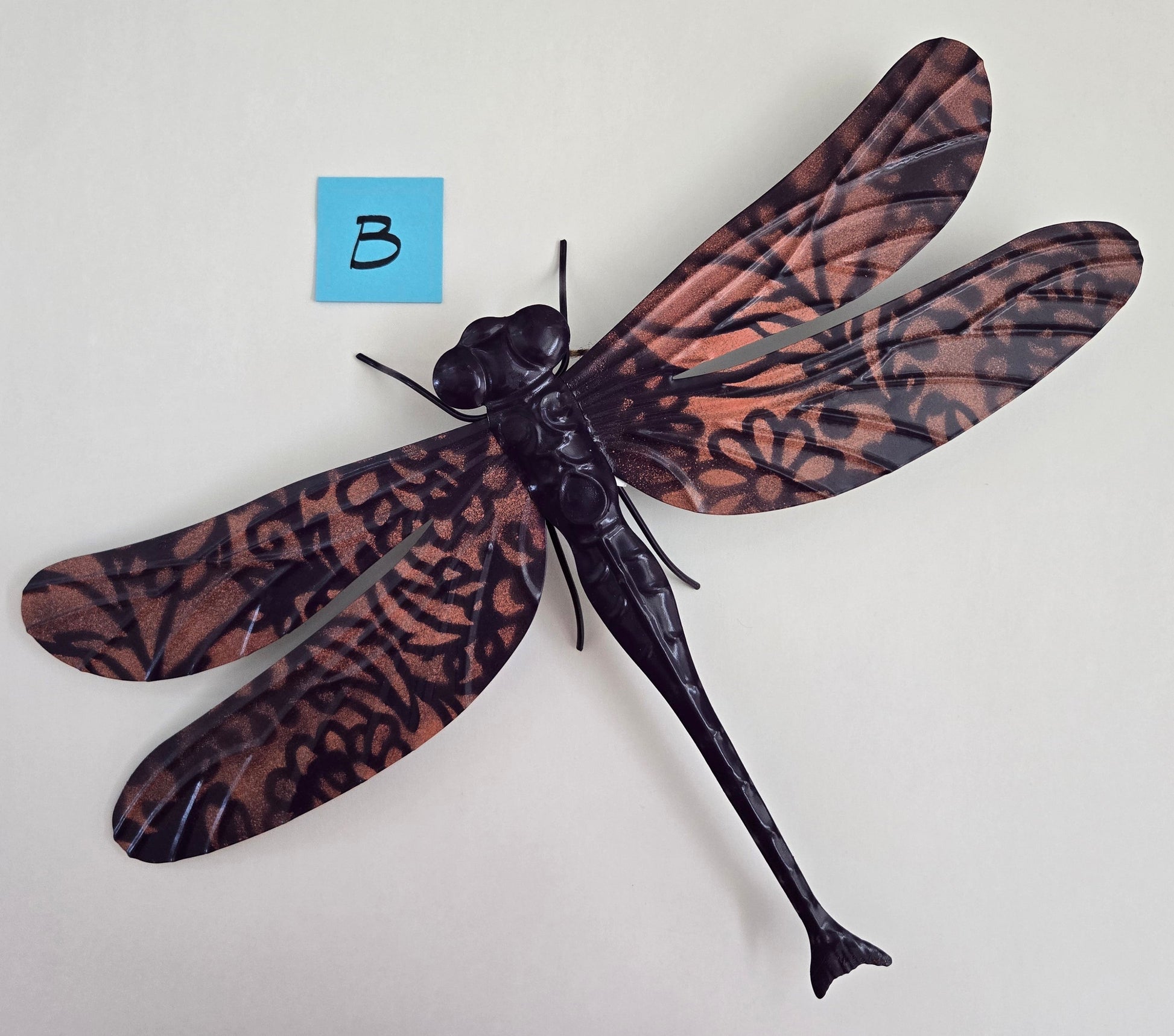 Decorative dragonfly wall art on a white background