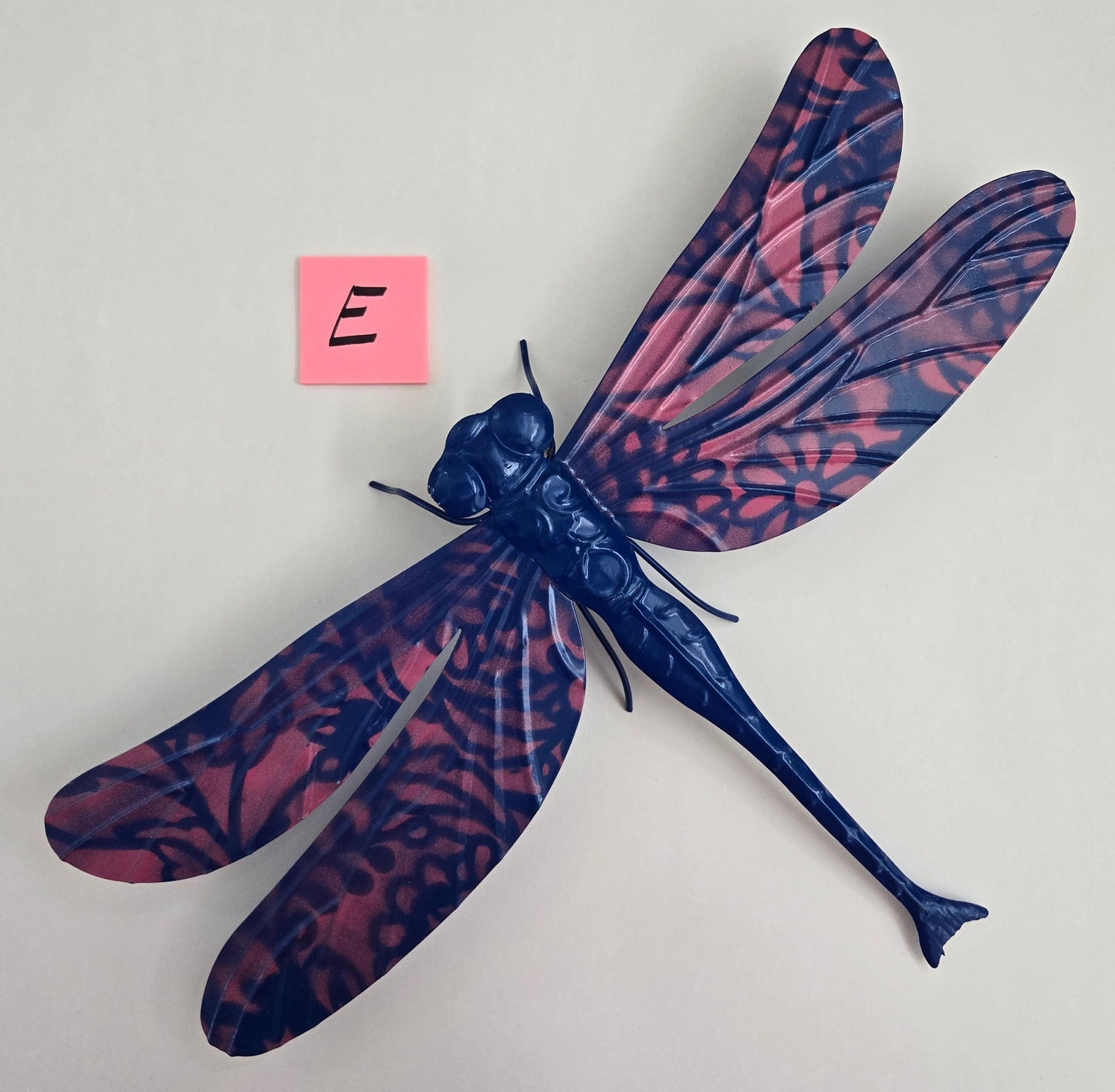 Decorative dragonfly wall art on light gray background