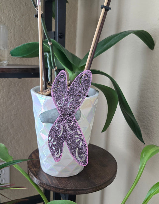 Decorative dragonfly on a plant with a blurred background