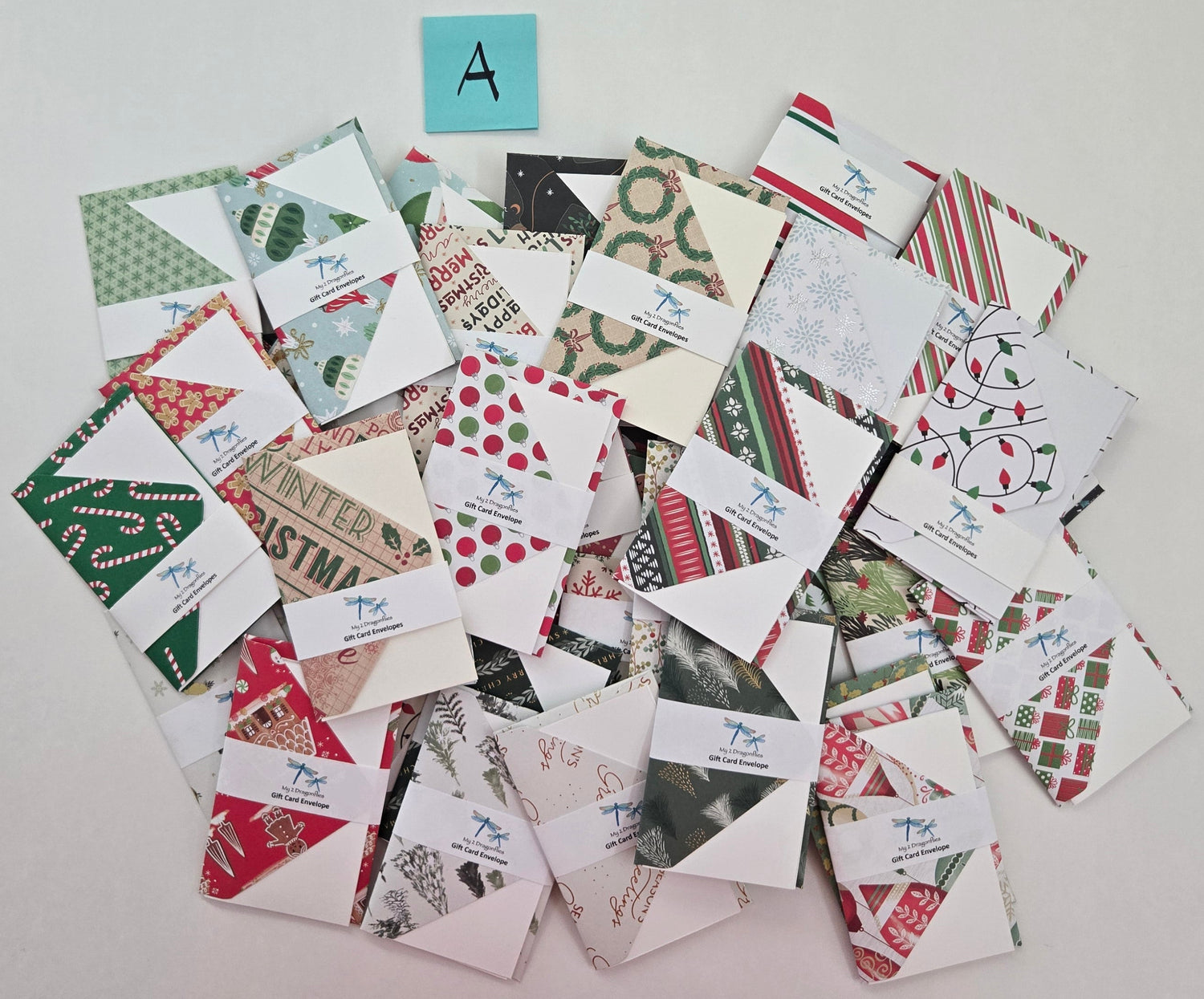 Collection of Christmas-themed cards on a white surface with colorful labels above.