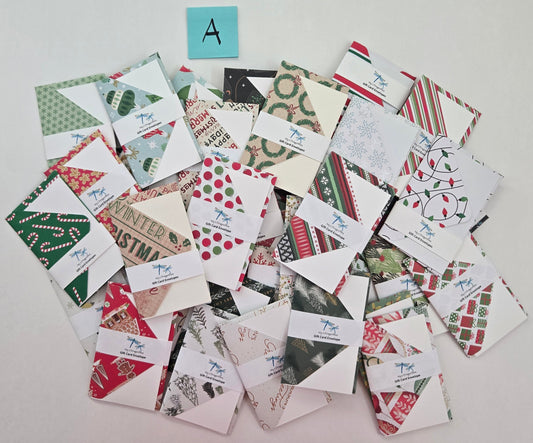 Collection of Christmas-themed cards on a white surface with colorful labels above.