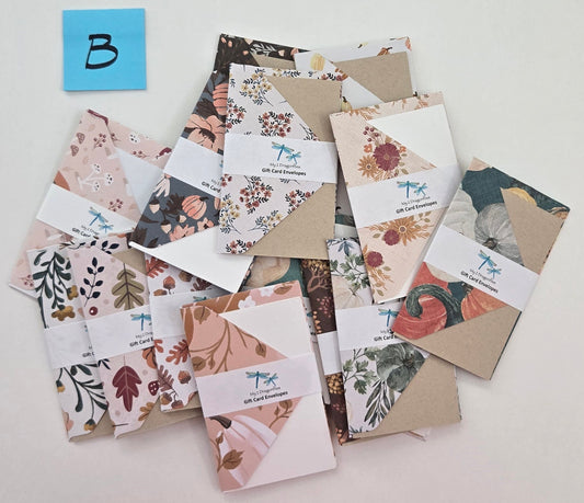 Collection of floral and nature-themed cards on a white surface with a 'B' label.