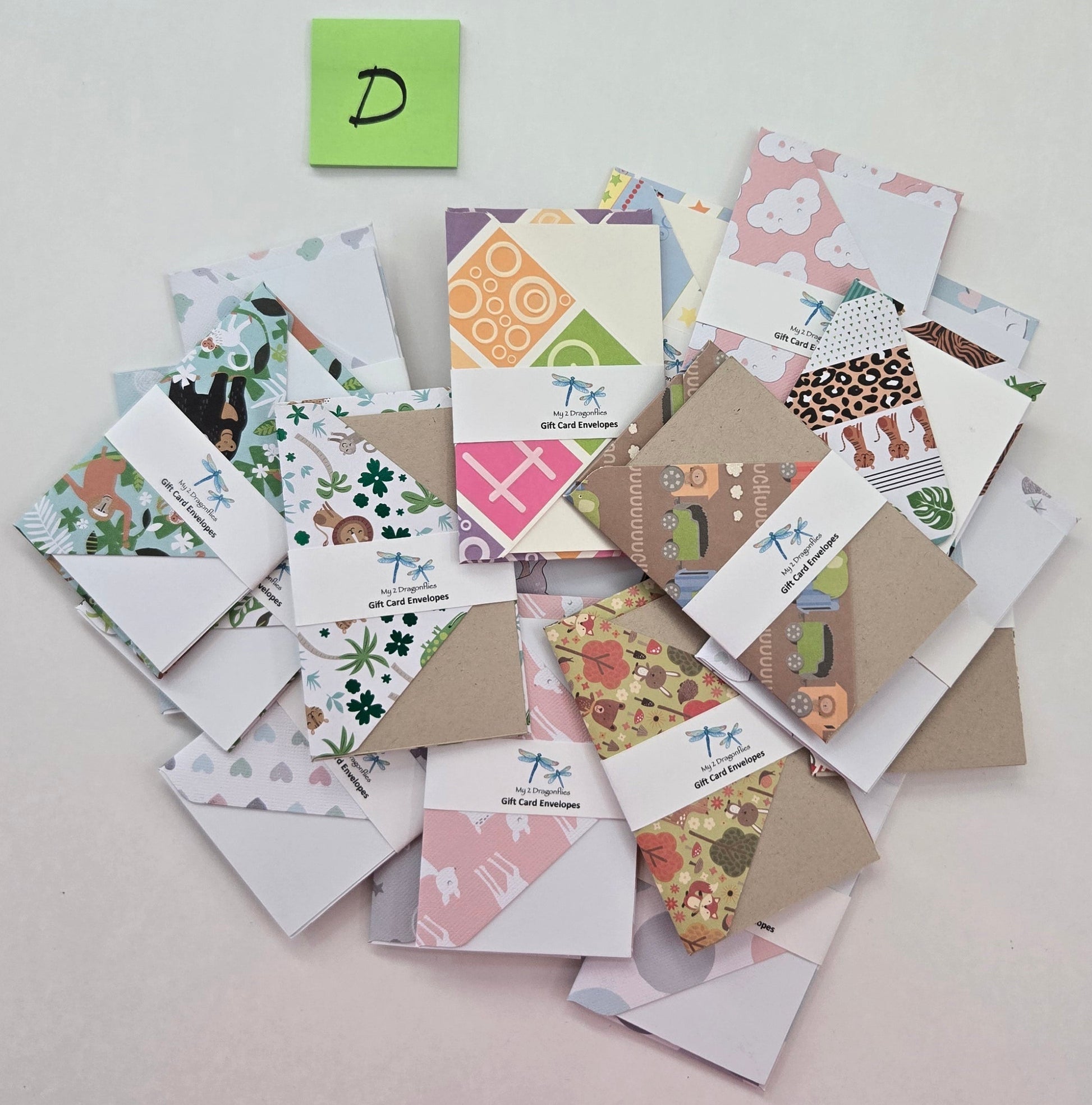 Collection of variously designed cards and envelopes on a light gray surface.