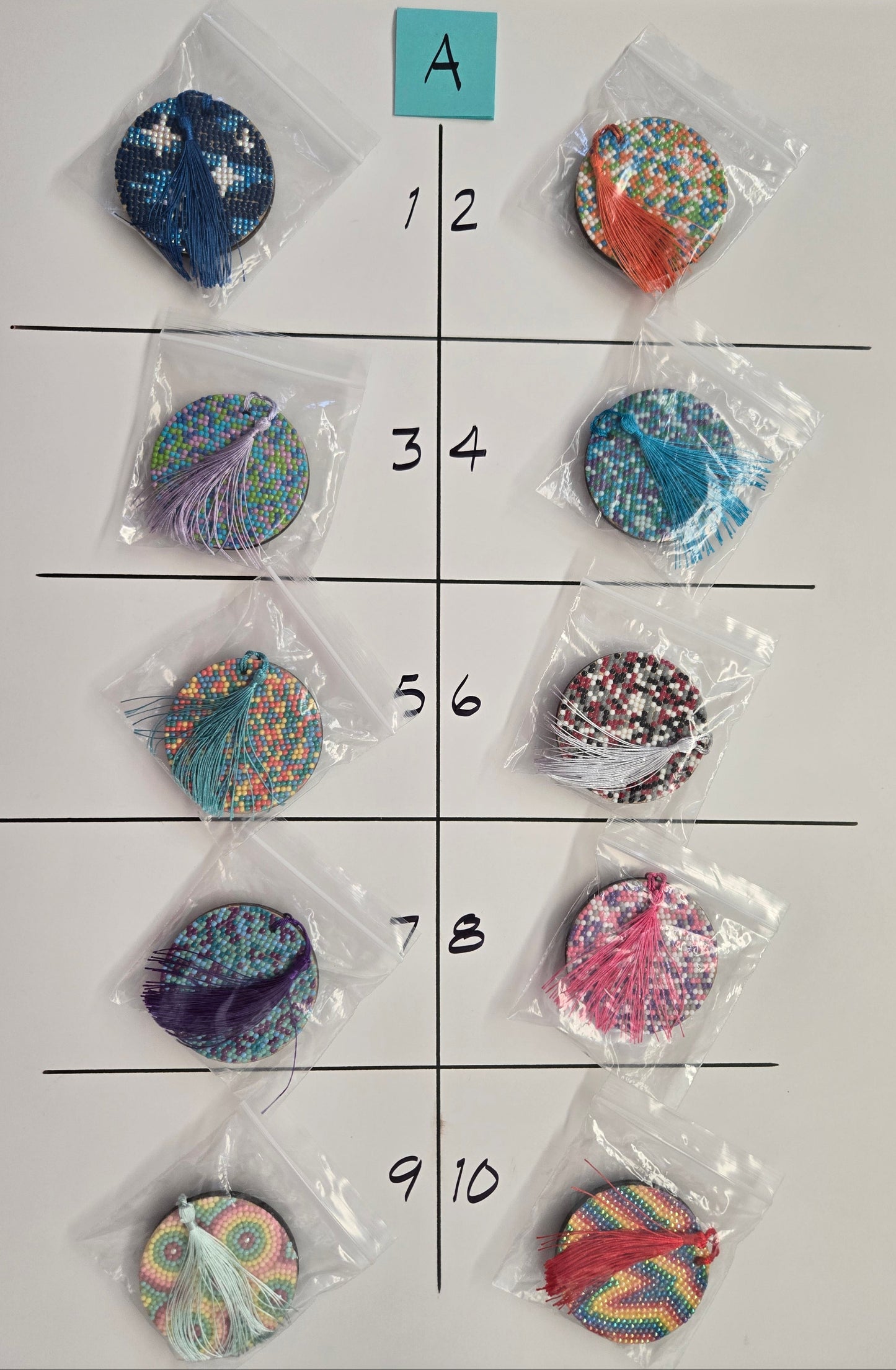 Colorful circular objects in clear packaging on a grid with labels.