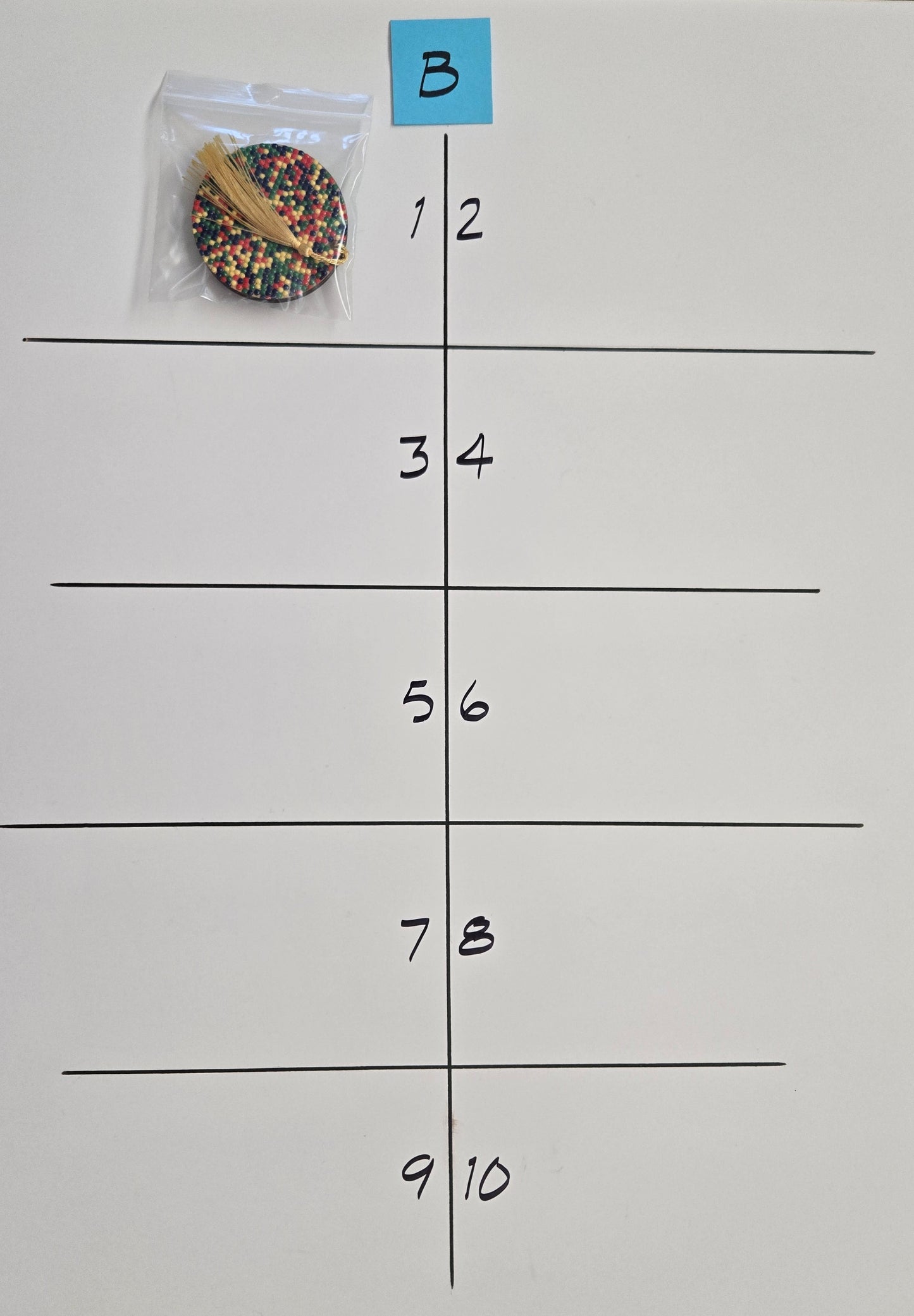 Colorful circular objects in a clear bag on a grid marked sheet