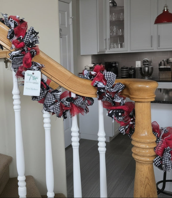 Decorative garland with red and black checkered pattern on a staircase railing in a home setting.